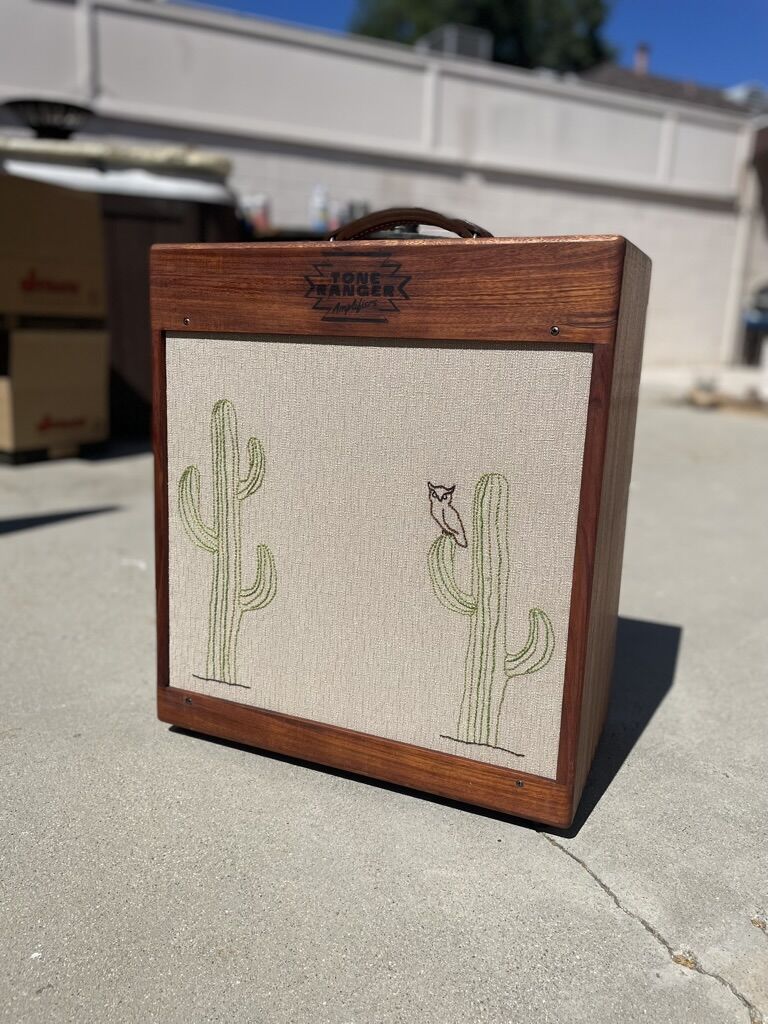 Cabinet with embroidered cacti photographed outdoors