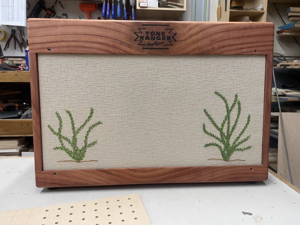 Wide cabinet with a pair of embroidered cacti