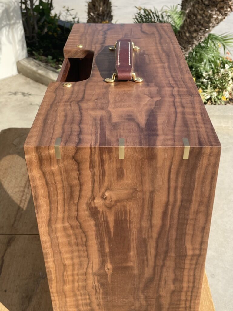 Figured walnut cabinet with a leather handle