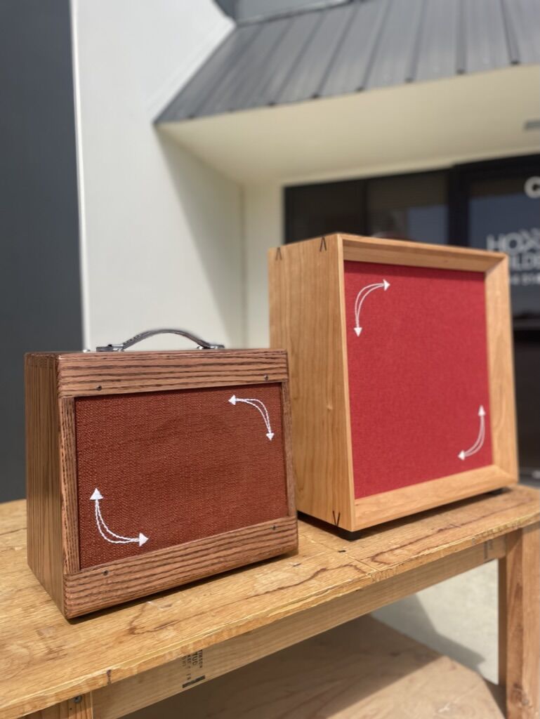 Two cabinets with red grill cloth and white embroidered arrows