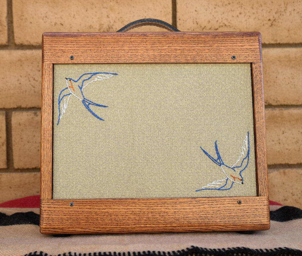 Oak cabinet with blue embroidered swallows